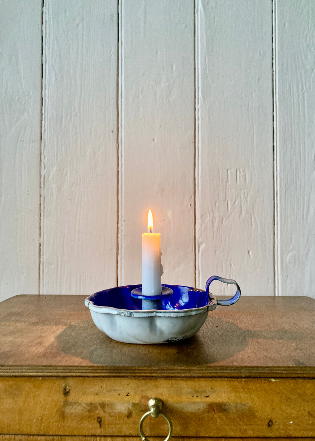 Blue enamel candle holder with scalloped form