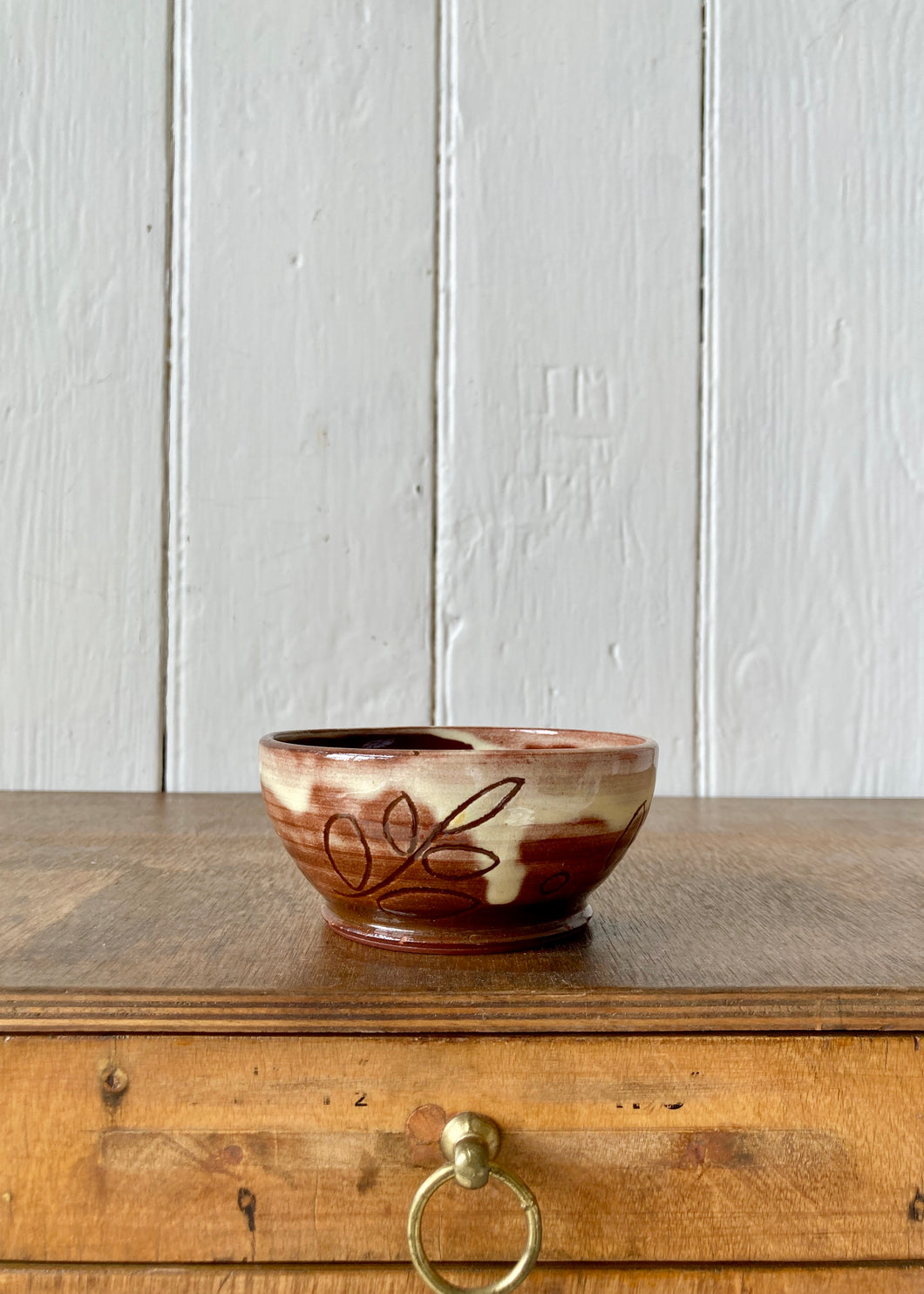 Studio pottery brown bowl with leaf decoration and slip glaze