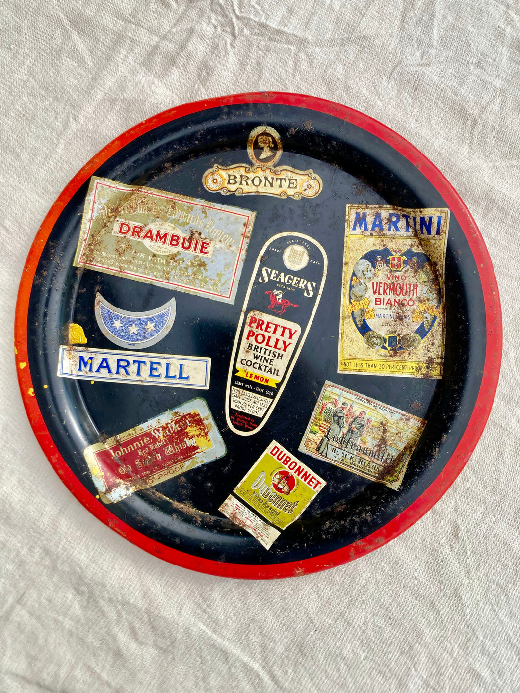 Small round vintage tray with vintage drinks labels